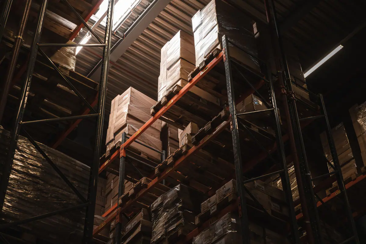 Tall warehouse racking stacked with cardboard boxes