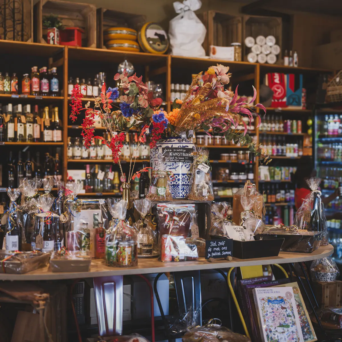 Shelves stocked with jars, bottles, baskets and dried flowers in a well-kept shop