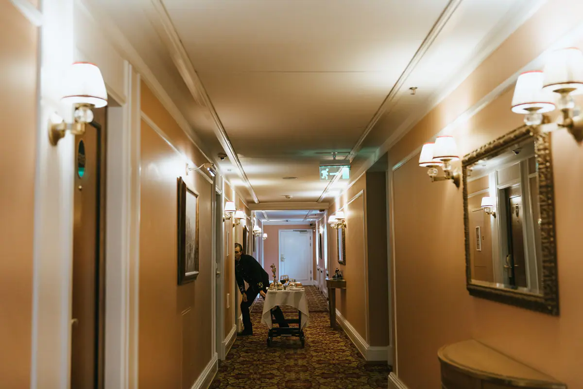 A hotel corridor with a housekeeping trolley