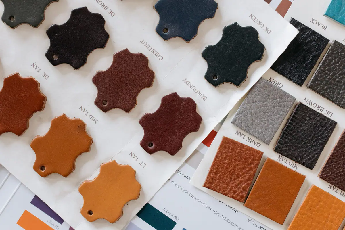 Leather samples in tan, oxblood and black laid out on a swatch card