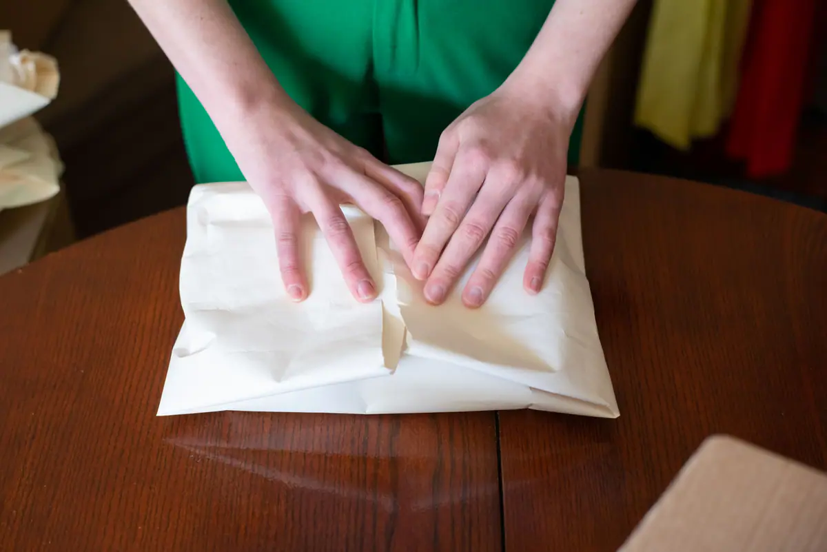 Hands wrapping a parcel for dispatch
